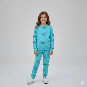Young girl wearing a blue Disney-themed pajama set on a light gray background