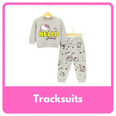 A young girl smiling and running in a bright studio while wearing a cream-colored sweatshirt and matching joggers with orange and brown autumn leaf prints. The sweatshirt features the text 'Winter is Beautiful' under three leaf graphics.