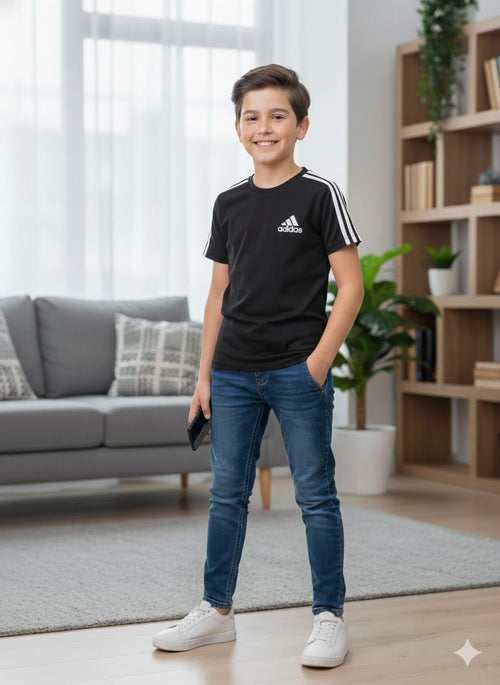Young boy wearing an Adidas t-shirt in a living room setting