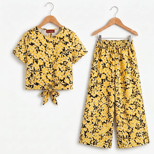 Yellow floral top with tie detail and matching wide-leg pants, perfect for girls' skate fashion.