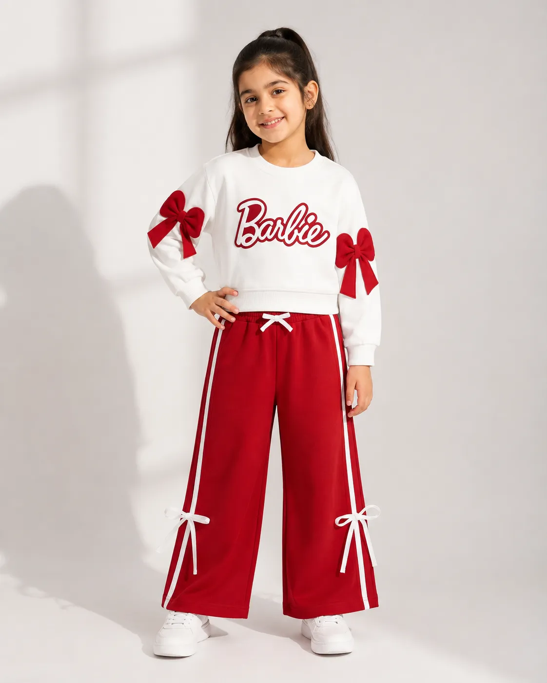 Terry white and red tracksuit for girls with bows on sleeves and pants, perfect for casual wear.