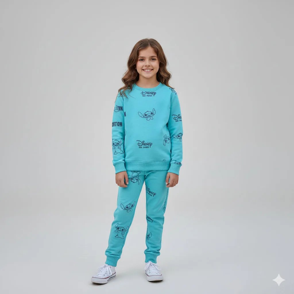 Young girl wearing a blue Disney-themed pajama set on a light gray background