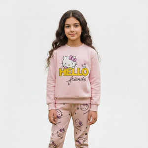 Young girl wearing a pink Hello Kitty outfit standing outdoors.
